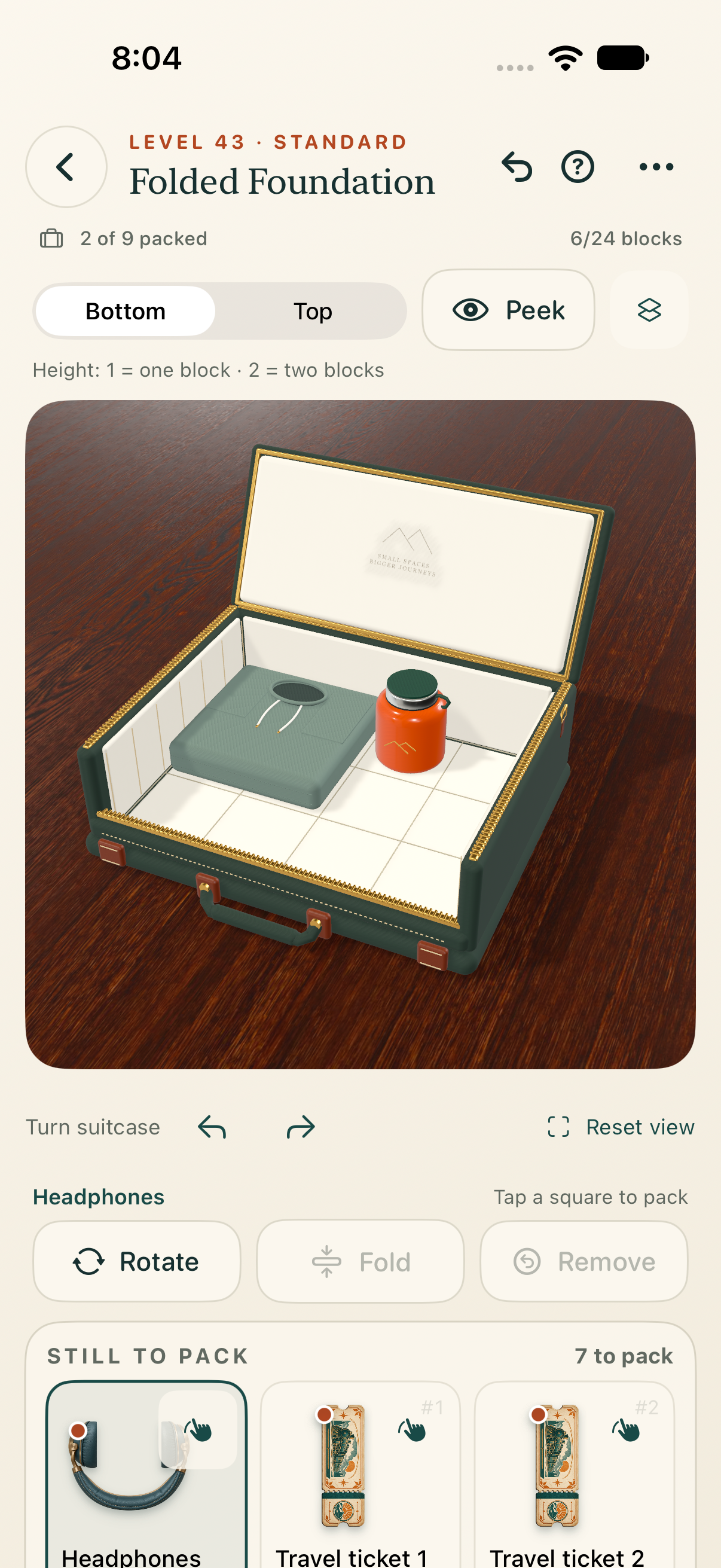 The packing game's teal suitcase and travel belongings